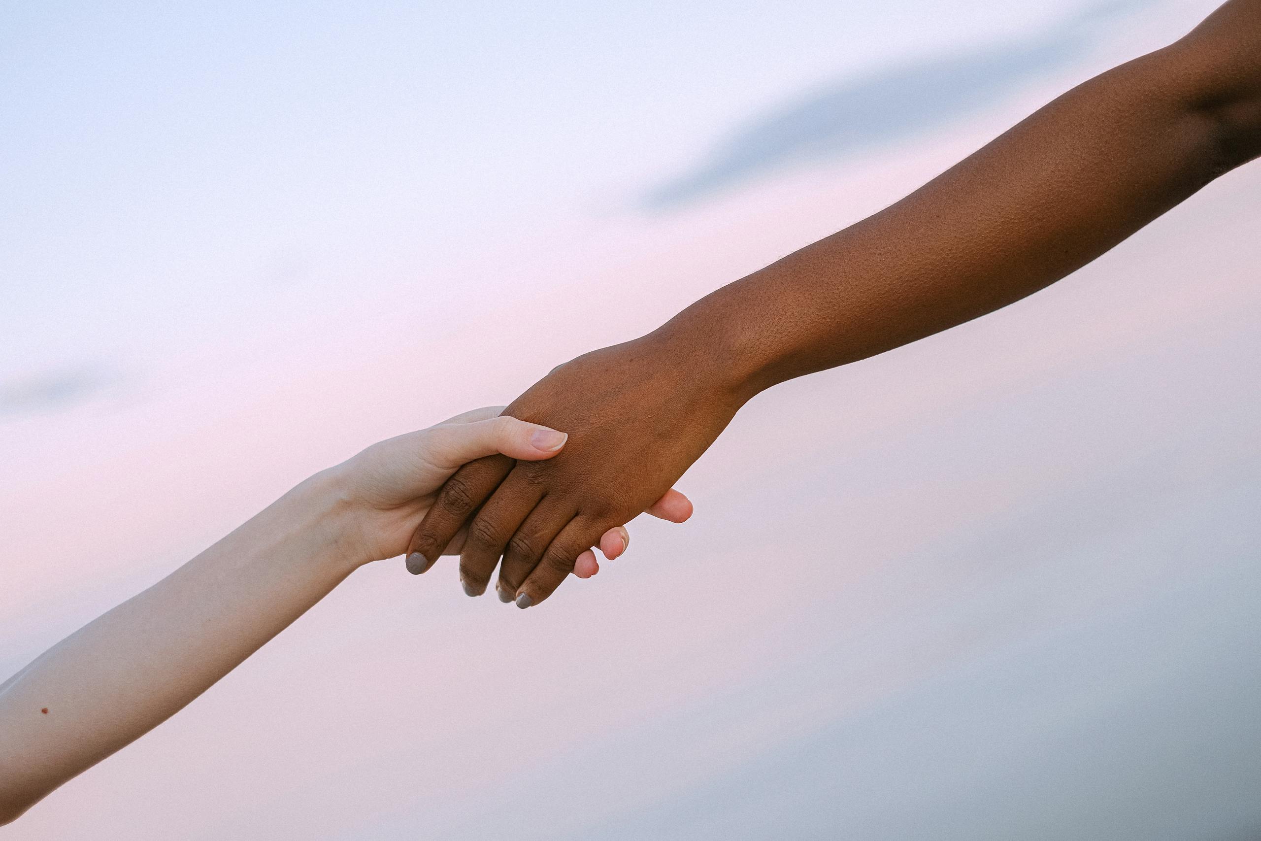 Photo Of People Holding Each Other's Hands